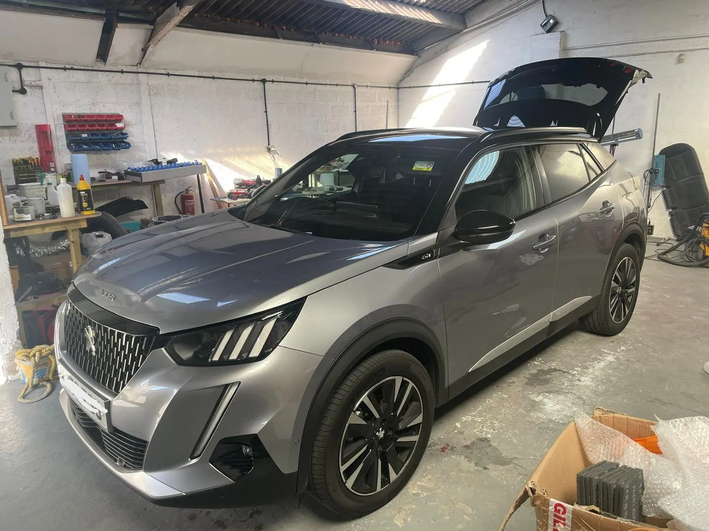 A car is parked inside of a garage.