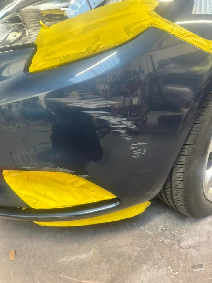 A close up of a car with yellow paint.